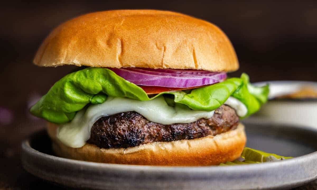 A close up view of Cayt's ranch burger on a gray plate.